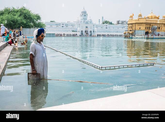amritsar-india-august-16-cleaner-of-the-holy-pond-around-the-sri-harmandir-sahib-or-golden-temple-on-august-16-2016-in-amritsar-india-2CKFNF4